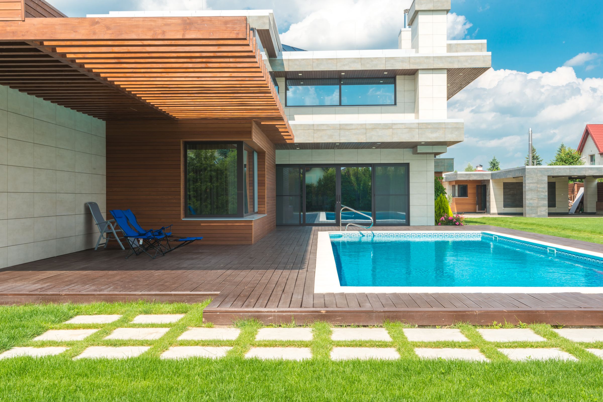 A sunlit home framed by mature landscaping